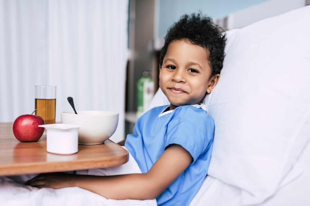 Smiling little boy with healthy meal